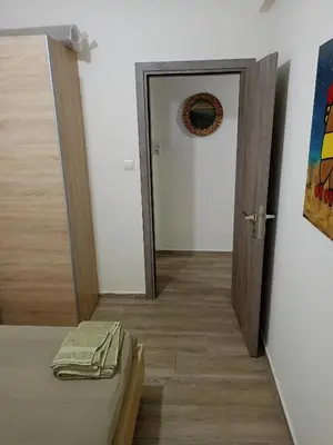 a door leading to a room with a bed and a mirror at Athens Center Cosy Apartment in Athens