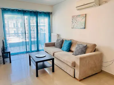 a living room with a couch and a table at Elvita Apartments 2 in Athens
