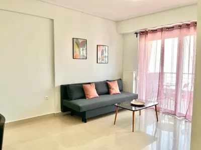 a living room with a couch and a table at Elvita Apartments 2 in Athens
