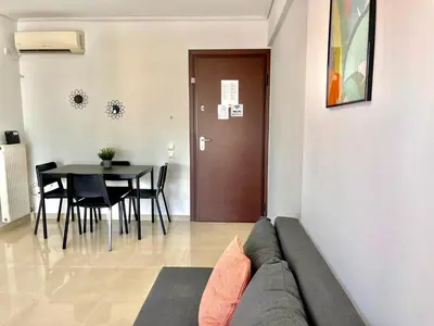 a living room with a couch and a table at Elvita Apartments 2 in Athens
