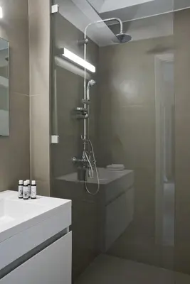 a bathroom with a shower and a sink at Parthenon Apartment in Athens