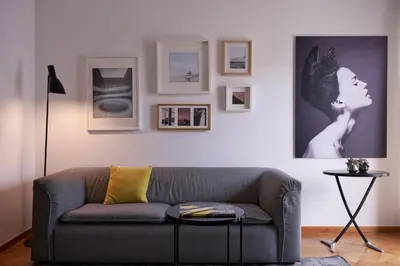 a living room with a couch and pictures on the wall at Parthenon Apartment in Athens