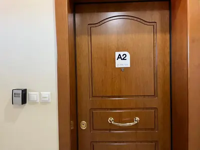 a wooden door with a sign on it at Hector Apartment Airport by Airstay in Spáta