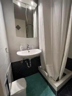 a bathroom with a sink and a toilet and a mirror at Hector Apartment Airport by Airstay in Spáta
