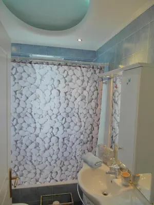 a bathroom with a shower with a toilet and a sink at Athens Metro Mall Apart in Athens