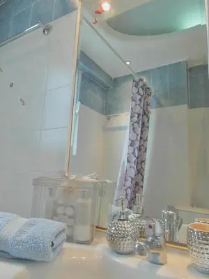 a bathroom counter with a sink with a mirror at Athens Metro Mall Apart in Athens