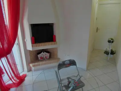 a living room with a tv and a fireplace at Athens Metro Mall Apart in Athens