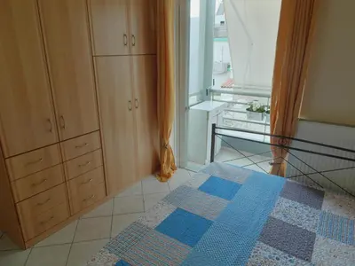 a bedroom with a bed and a window and a rug at Athens Metro Mall Apart in Athens