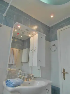 a bathroom with a sink and a mirror at Athens Metro Mall Apart in Athens