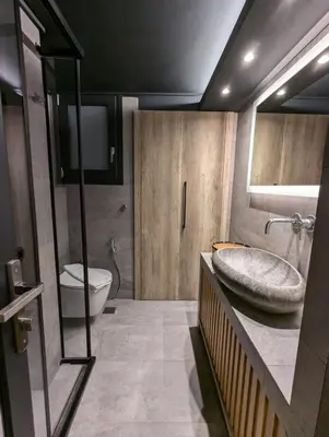 a bathroom with a sink and a toilet at Be My Guest Athens in Athens