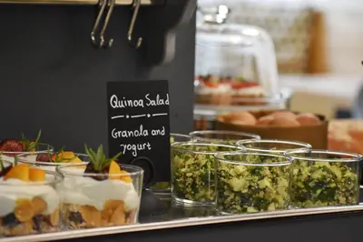 a buffet with desserts in glasses on a table at Be My Guest Athens in Athens