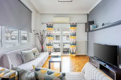 a living room with couches and a flat screen tv at Apartment in the Middle of Everything in Athens