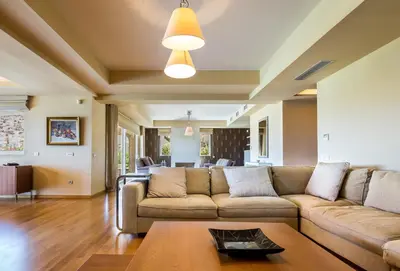 a living room with a couch and a table at Analisa Luxury Villa in Sounio
