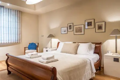 a bedroom with a large bed with towels on it at Analisa Luxury Villa in Sounio