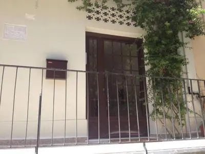 a front door of a building with a fence at Cozy apartment in Acropolis with roof garden in Athens