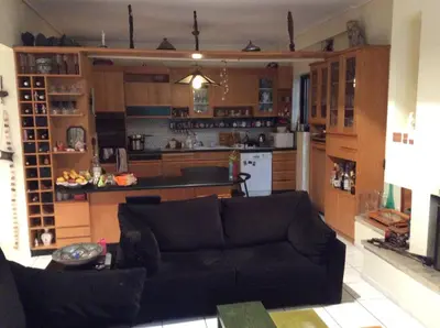 a living room with a couch and a kitchen at Filyra Homestay (Όμορφο δωμάτιο σε σπίτι) in Athens