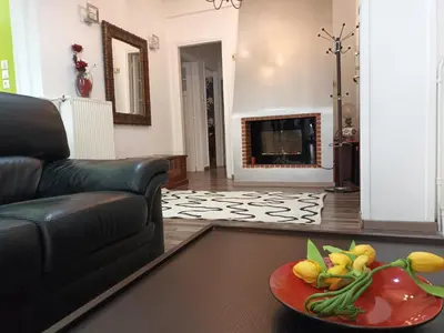 a living room with a couch and a plate of flowers at Stunning apartment in the heart of Athens in Athens