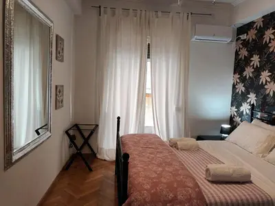 a small bedroom with a bed and a window at Stunning apartment in the heart of Athens in Athens