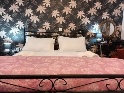 a bedroom with a bed with a flowery wallpaper at Stunning apartment in the heart of Athens in Athens