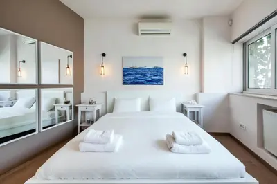 a bedroom with a large white bed with two pillows at K5 - Walk into Heritage in Athens