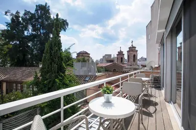 a balcony with a table and chairs and a view of the city at K5 - Walk into Heritage in Athens