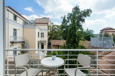 a balcony with a white table and chairs at K5 - Walk into Heritage in Athens