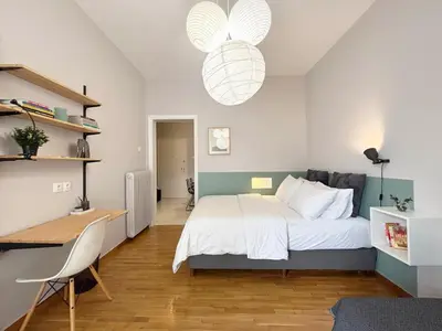 a bedroom with a bed and a desk and a desk at The CucuWow in Athens