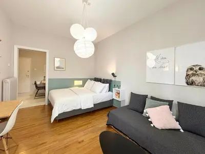 a bedroom with a bed and a couch at The CucuWow in Athens