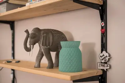 a toy elephant on a shelf with a vase at The CucuWow in Athens