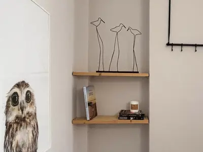 an owl is sitting on a shelf in a room at The CucuWow in Athens