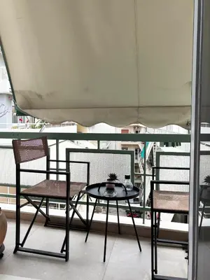 a table and two chairs sitting on a balcony at The CucuWow in Athens