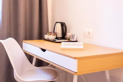 a desk in a room with a telephone and a chair at Stone Palace Hotel Near Athen's Airport Free Shuttle From and to Athen's Airport in Spáta