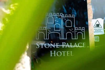 a picture of a stone palace hotel sign at Stone Palace Hotel Near Athen's Airport Free Shuttle From and to Athen's Airport in Spáta