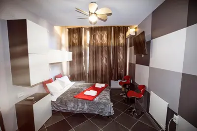 a bedroom with a bed with a red blanket at Trendy Living in Monastiraki in Athens