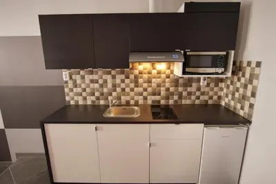 a kitchen with a sink and a microwave at Trendy Living in Monastiraki in Athens