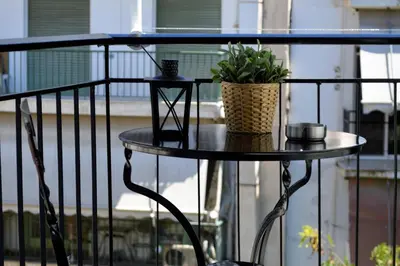 a table with a potted plant on a balcony at Athens Nest in Athens