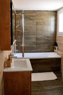a bathroom with a bath tub and a sink at Athens Nest in Athens