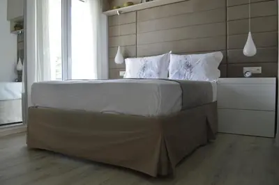 a bedroom with a large bed with white sheets and pillows at Athens Nest in Athens