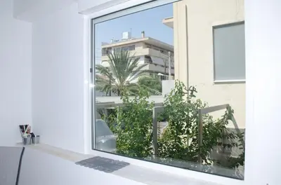 an open window with a view of a building at Holiday Apartment Glyfada in Athens