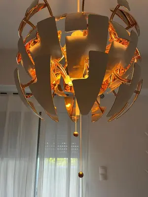a chandelier hanging from the ceiling in a room at Holiday Apartment Glyfada in Athens