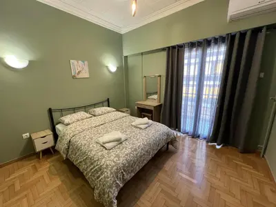 a bedroom with a bed with two pillows on it at Sfiggos 54 Guest House in Athens