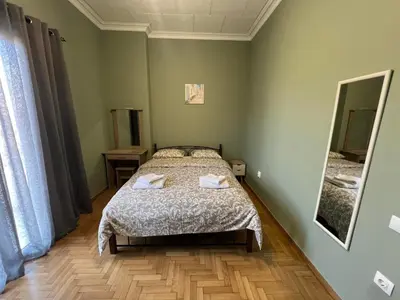 a small bedroom with a bed and a mirror at Sfiggos 54 Guest House in Athens