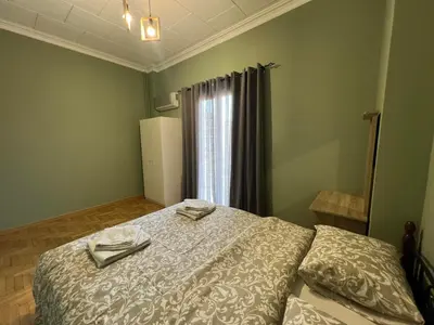 a bedroom with a bed with two utensils on it at Sfiggos 54 Guest House in Athens