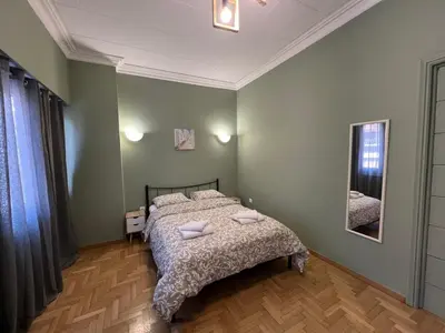 a bedroom with a bed with two pillows on it at Sfiggos 54 Guest House in Athens