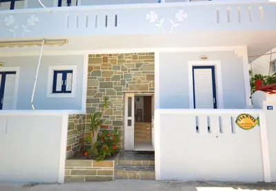 a house with a blue and white facade at Yiannis Studios in Agia Marina Aegina