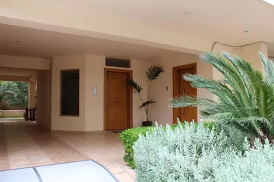 a house with a courtyard with plants and a door at Luxurious Loft with Garden in Athens