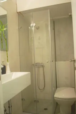 a bathroom with a shower and a toilet and a sink at Luxurious Loft with Garden in Athens