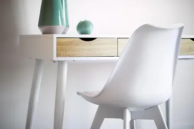 a white desk with a white chair and a green vase at Elaia Luxury Suites Lagonisi in Lagonissi