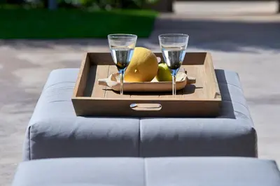 a table with two wine glasses and a plate of fruit at Elaia Luxury Suites Lagonisi in Lagonissi