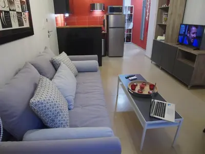 a living room with a blue couch and a table at Under the shade of Acropolis by YHA in Athens